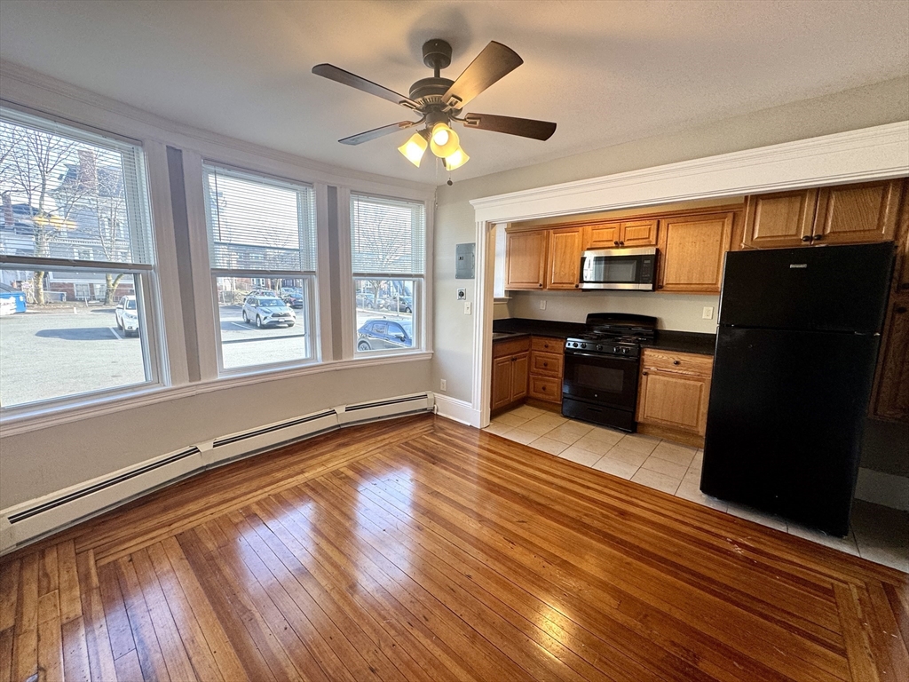 124 Green Street, Unit 206 Lynn, MA 01902 - Photo 1 of 7 a large kitchen with stainless steel appliances granite countertop a refrigerator a stove and a wooden floors