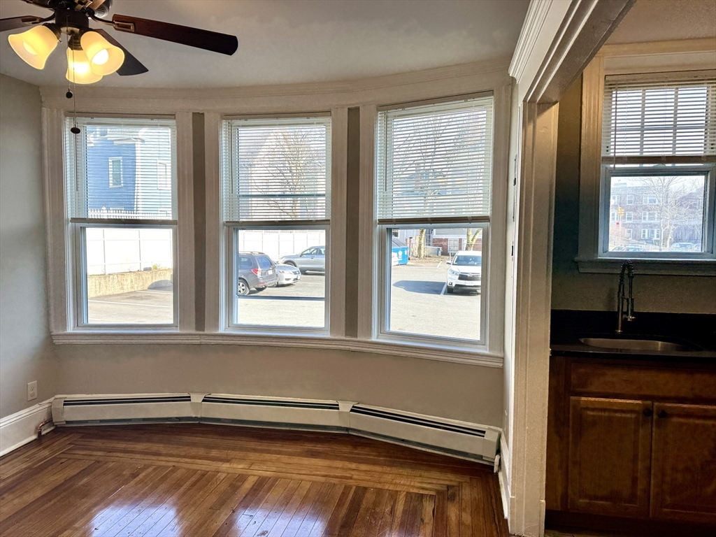 124 Green Street, Unit 206 Lynn, MA 01902 - Photo 4 of 7 a view of an empty room with a window and a kitchen