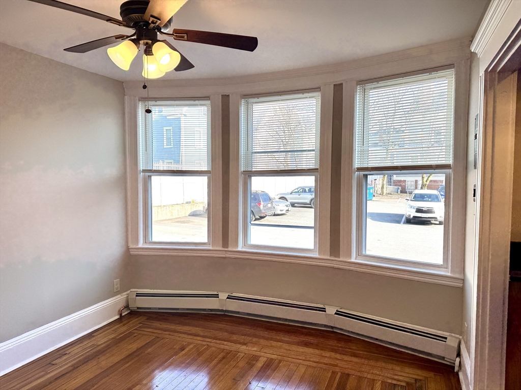 124 Green Street, Unit 206 Lynn, MA 01902 - Photo 5 of 7 a view of an empty room with window and wooden floor