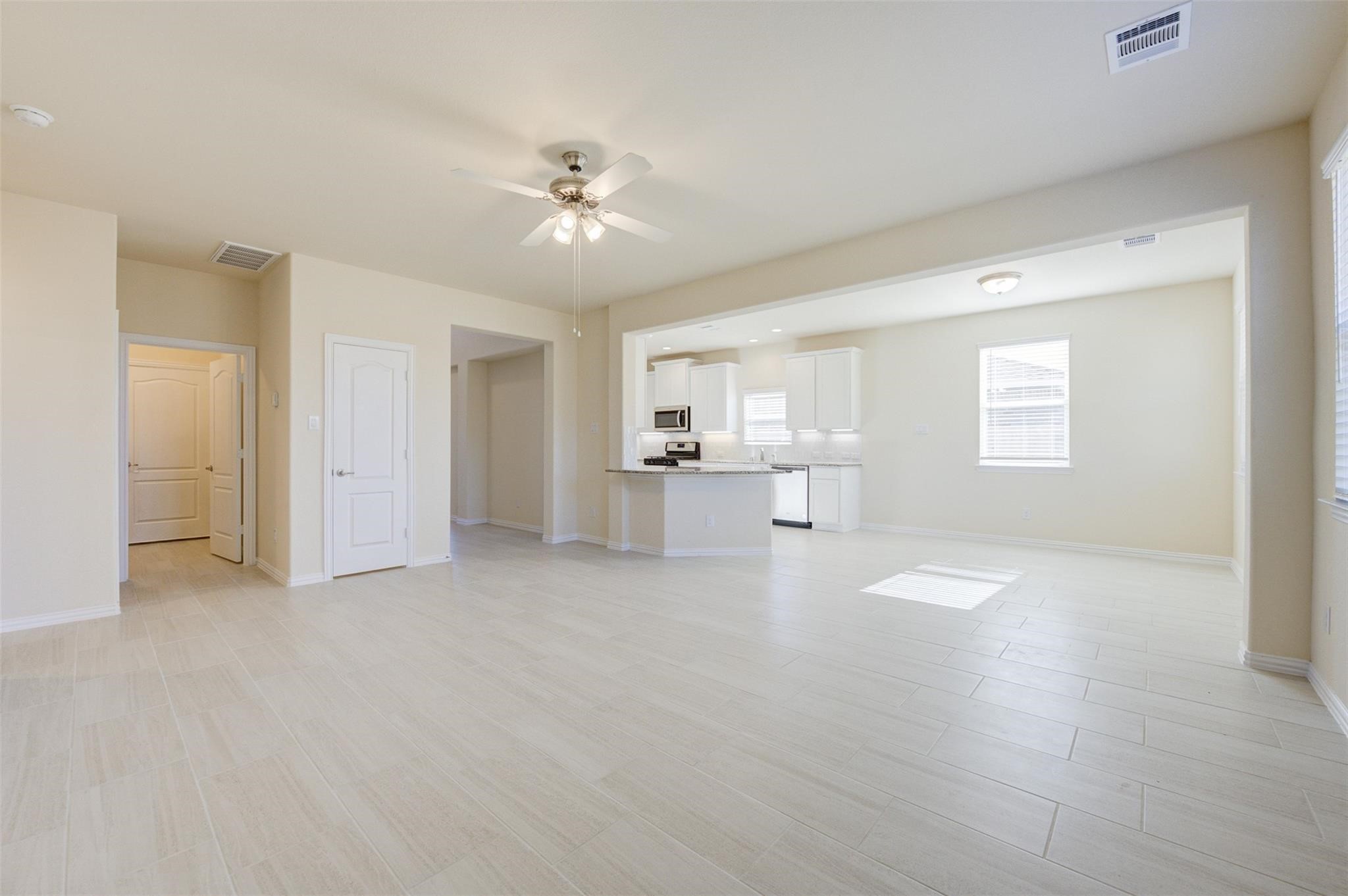 10902 Granite Chief Drive Rosharon, TX 77583 - Photo 15 of 32 a view of a big room with windows and chandelier fan