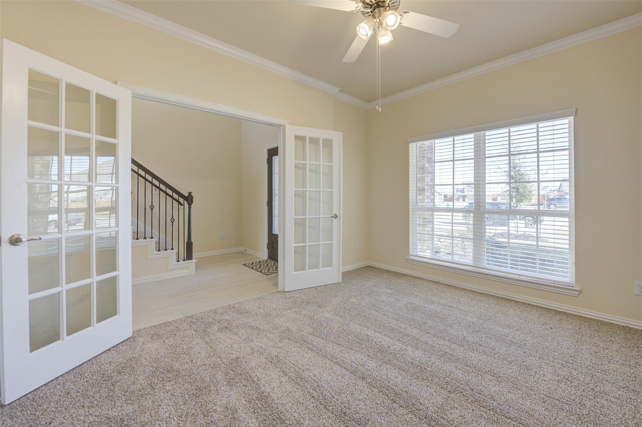 10902 Granite Chief Drive Rosharon, TX 77583 - Photo 6 of 32 an empty room with chandelier fan and windows