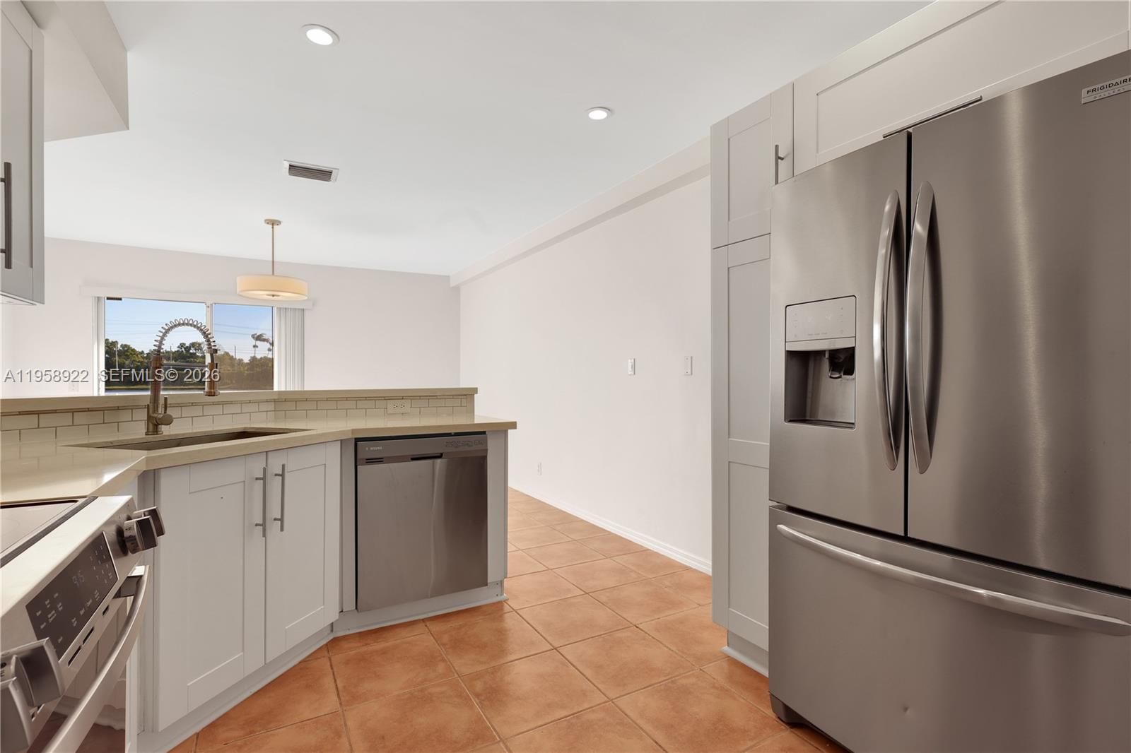 5467 Southwest 125th Terrace Miramar, FL 33027 - Photo 14 of 42 a kitchen with stainless steel appliances a refrigerator and a sink