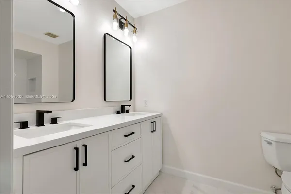 a bathroom with a double vanity sink and mirror