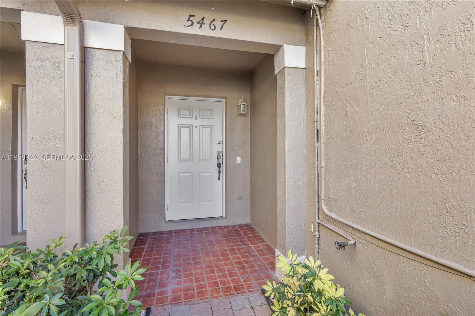 5467 Southwest 125th Terrace Miramar, FL 33027 - Photo 2 of 42 a view of a hallway with flower plants