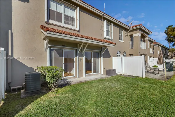 a view of a house with a yard and sitting area