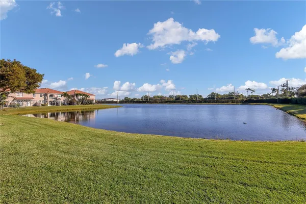 a view of a lake with houses in the back