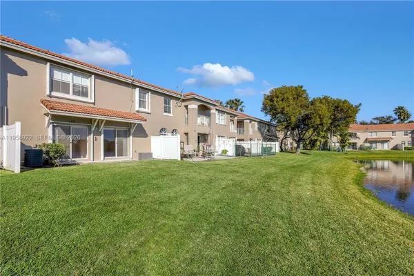 a view of a house with a yard and sitting area