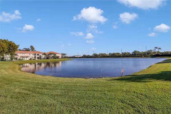 a view of a lake with houses in the back