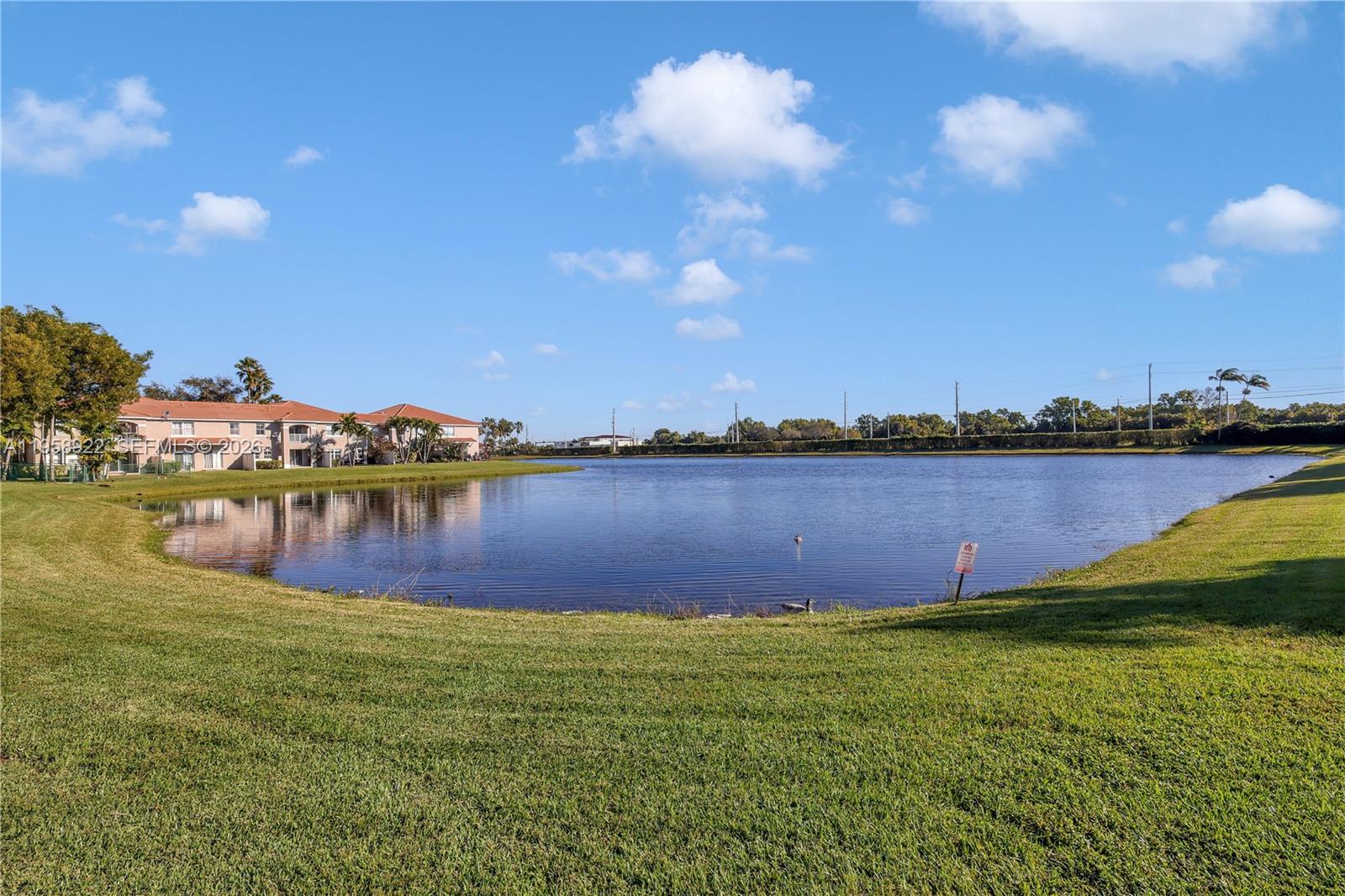 5467 Southwest 125th Terrace Miramar, FL 33027 - Photo 30 of 42 a view of a lake with houses in the back