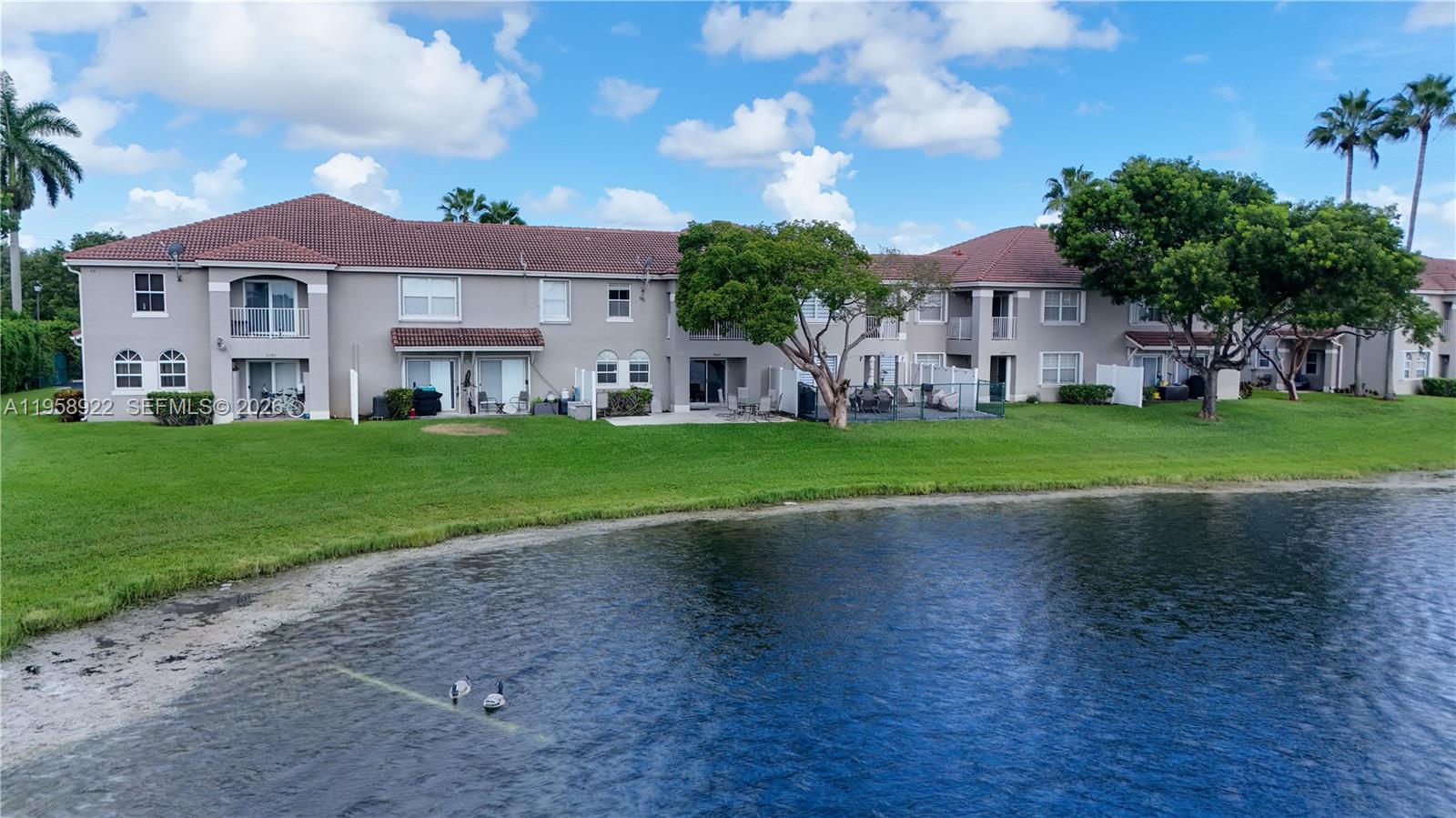 5467 Southwest 125th Terrace Miramar, FL 33027 - Photo 33 of 42 a front view of a house with a garden and yard