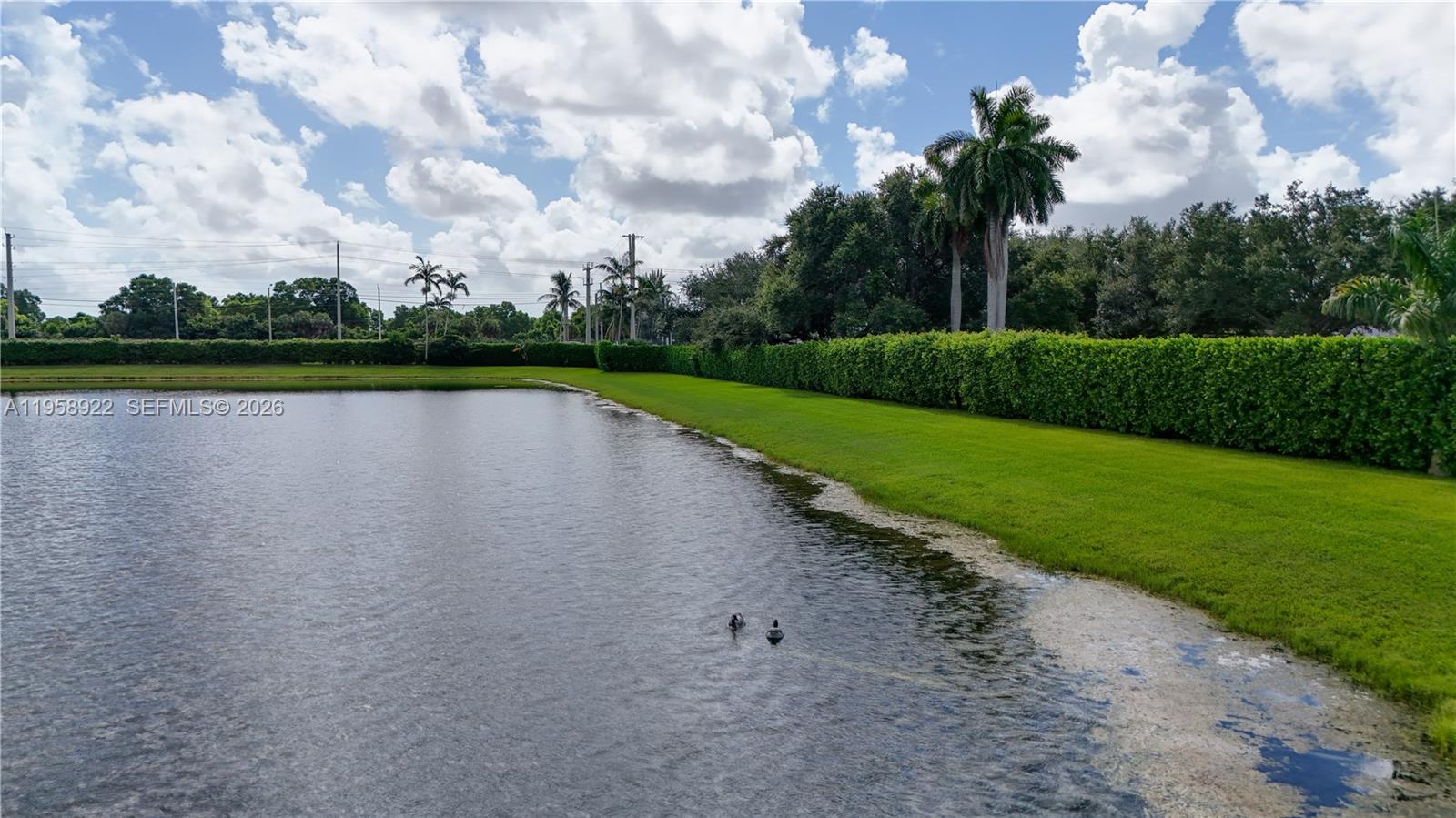 5467 Southwest 125th Terrace Miramar, FL 33027 - Photo 35 of 42 a view of a lake with a big yard