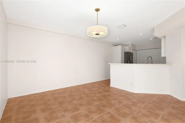 a view of a room with a ceiling fan and wooden floor