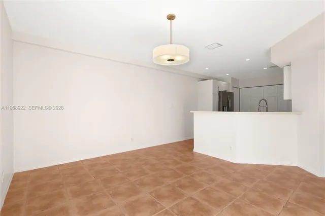 a view of a room with a ceiling fan and wooden floor