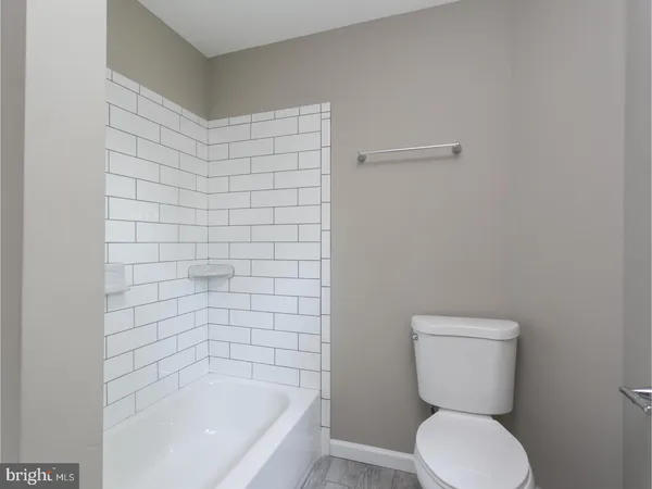 a bathroom with a toilet and bathtub