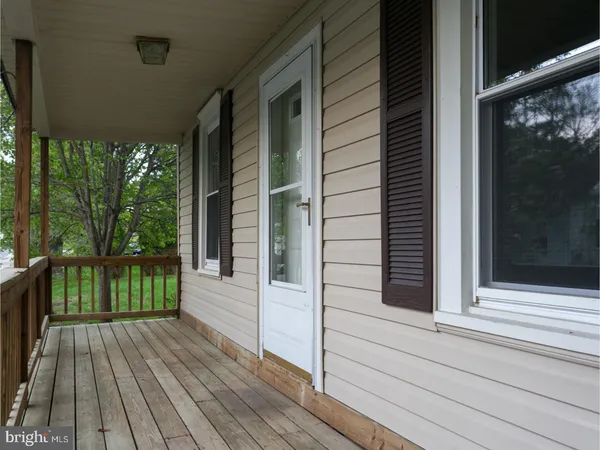 a view of a balcony with door and wooden floor