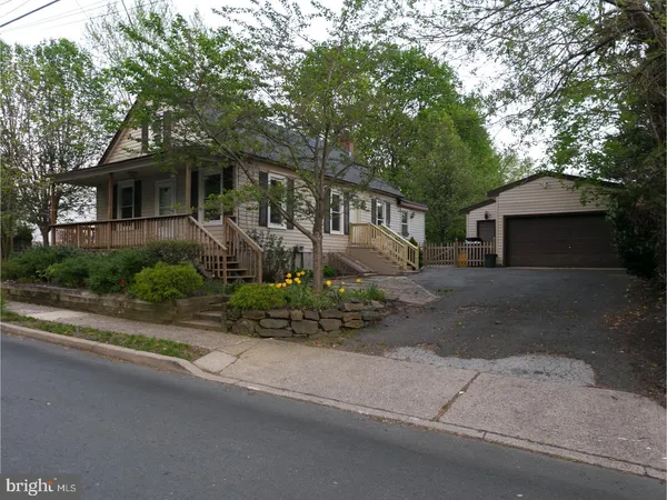 a front view of a house with a yard and a garage
