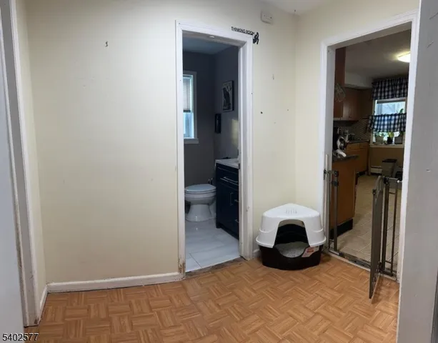 a view of a livingroom with furniture and a hallway