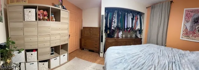 a bedroom with a bed and a mirror