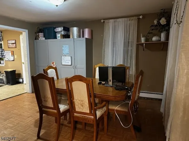 a view of a dining room with furniture and a window