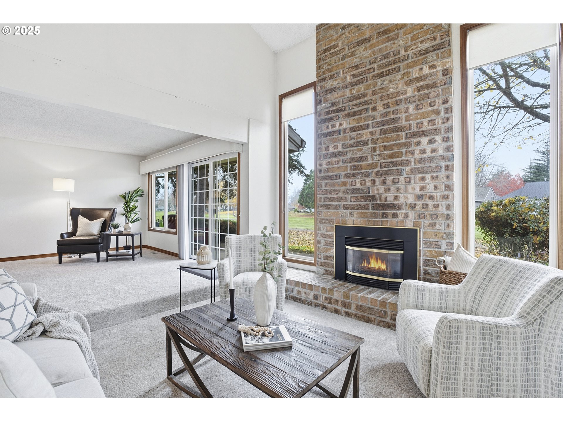 7430 Southwest Greens View Court Wilsonville, OR 97070 - Photo 14 of 48 a living room with furniture a fireplace and a floor to ceiling window