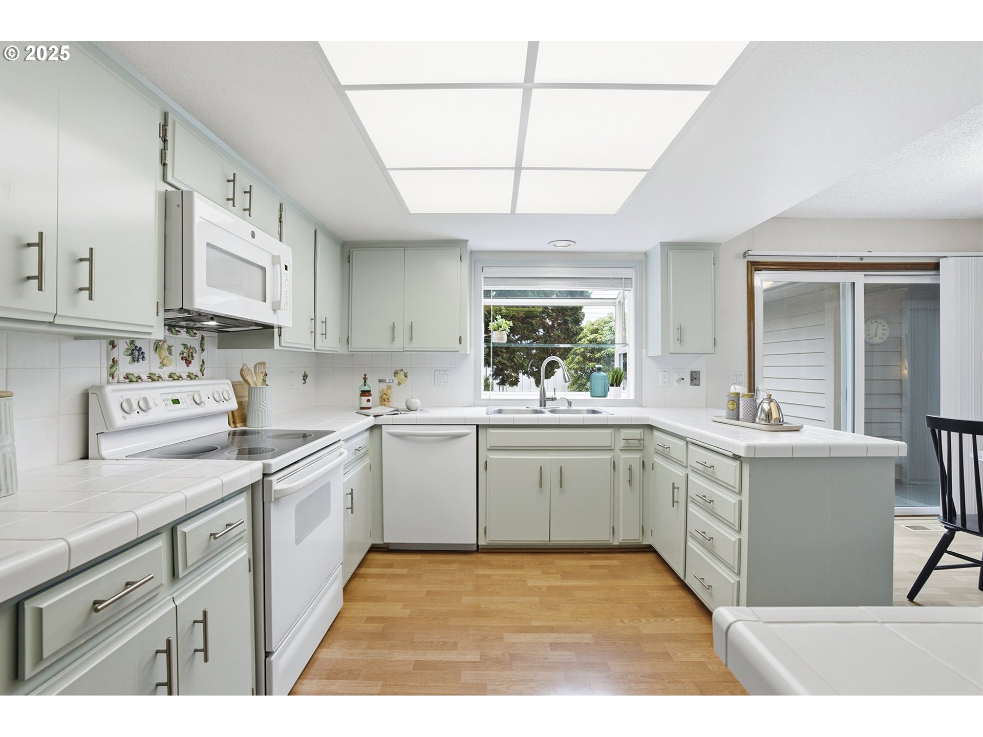 7430 Southwest Greens View Court Wilsonville, OR 97070 - Photo 16 of 48 a kitchen with a sink cabinets appliances and a window
