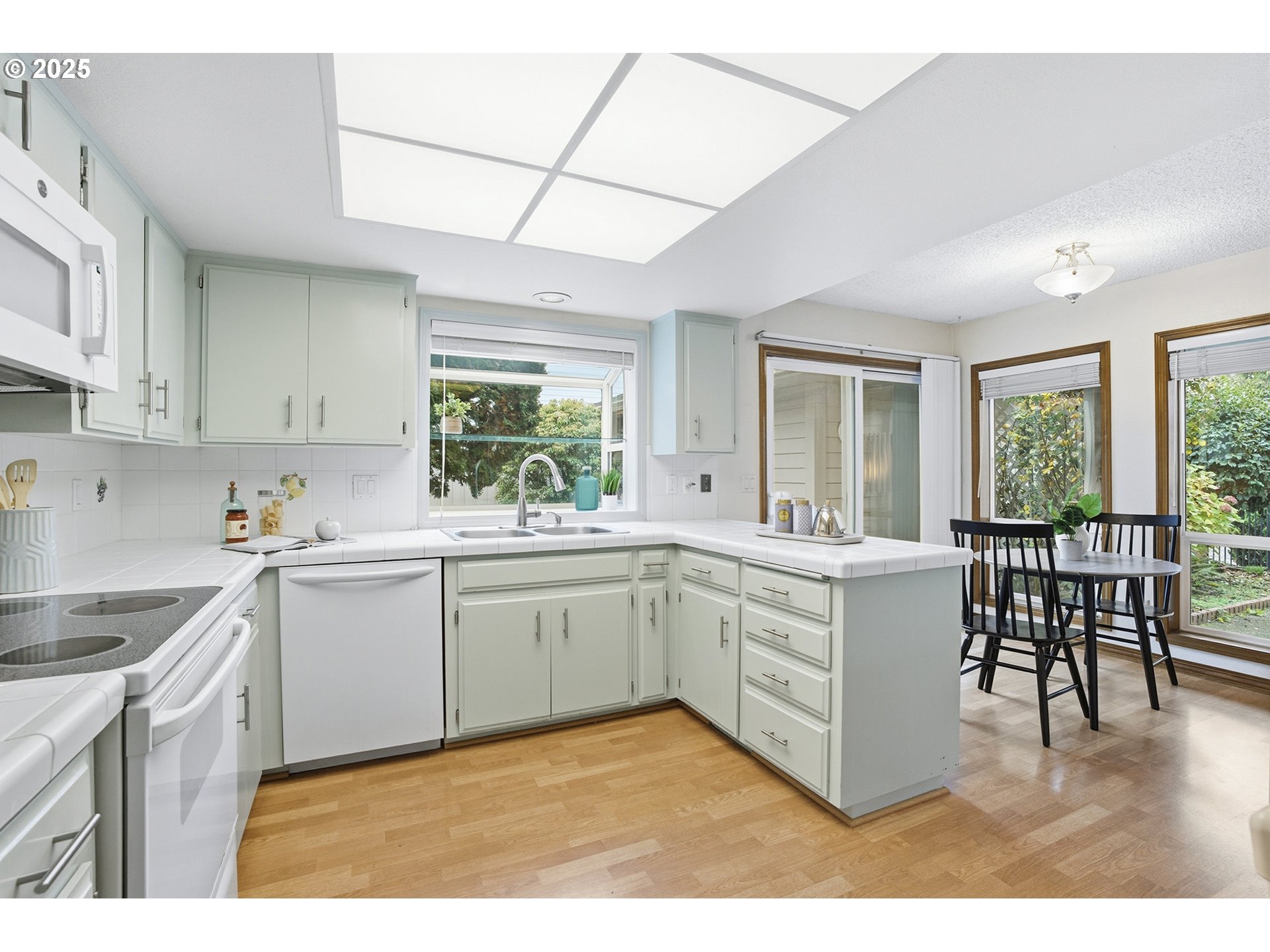 7430 Southwest Greens View Court Wilsonville, OR 97070 - Photo 17 of 48 a kitchen with a sink cabinets and dining table
