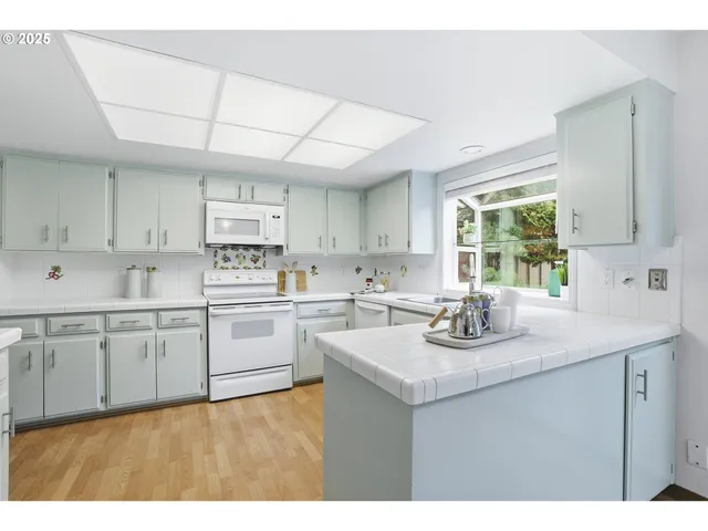 a kitchen with sink cabinets and window