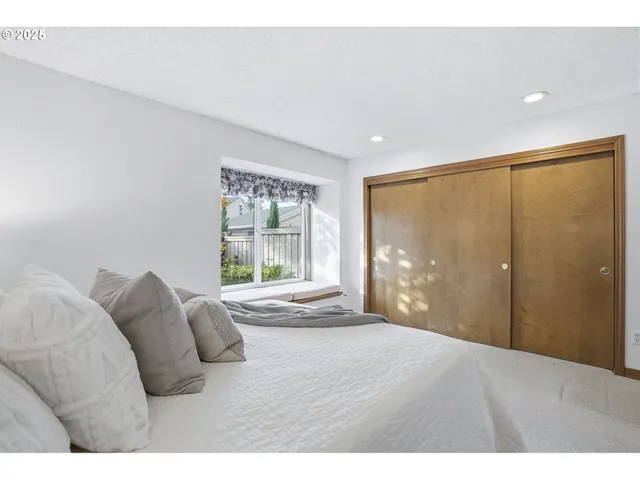 a bedroom with a large bed and a large window
