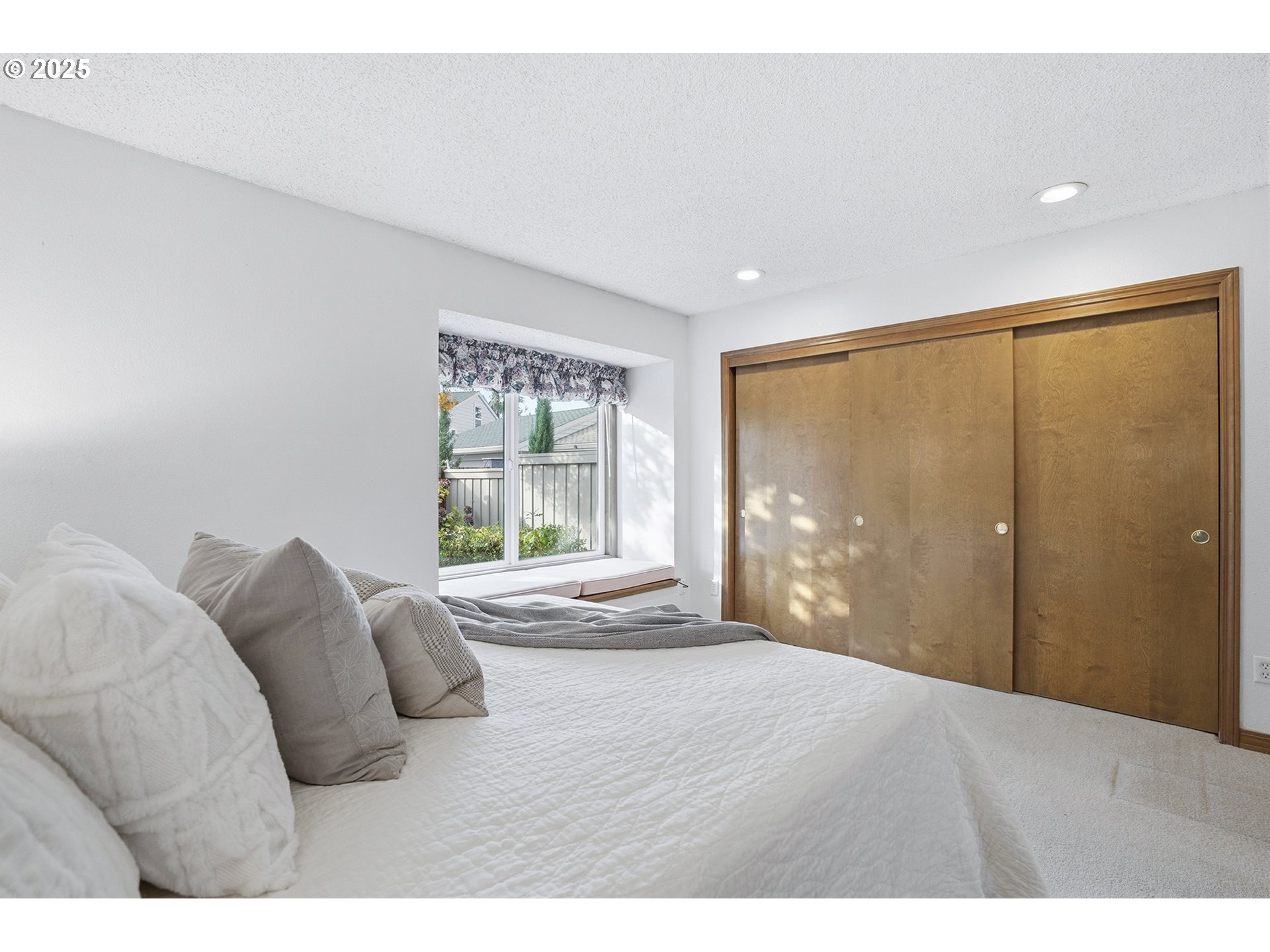 7430 Southwest Greens View Court Wilsonville, OR 97070 - Photo 26 of 48 a bedroom with a large bed and a large window