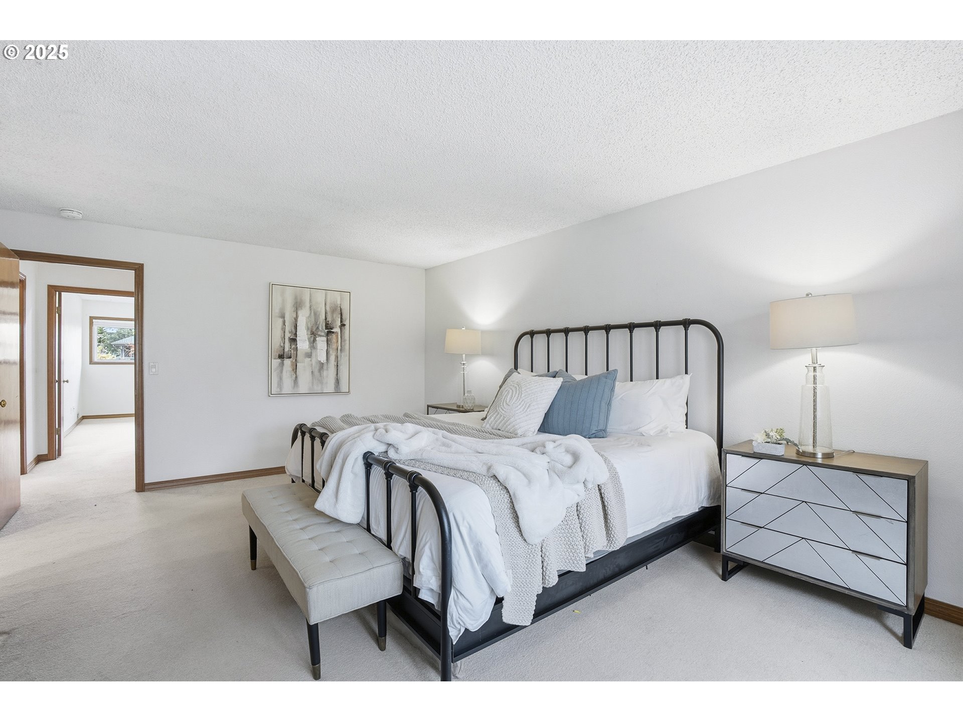 7430 Southwest Greens View Court Wilsonville, OR 97070 - Photo 30 of 48 a bedroom with a bed a mirror and lamp