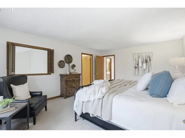 a bedroom with a bed and chair