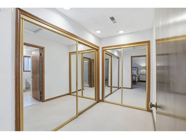 a view of a big room with windows and entryway