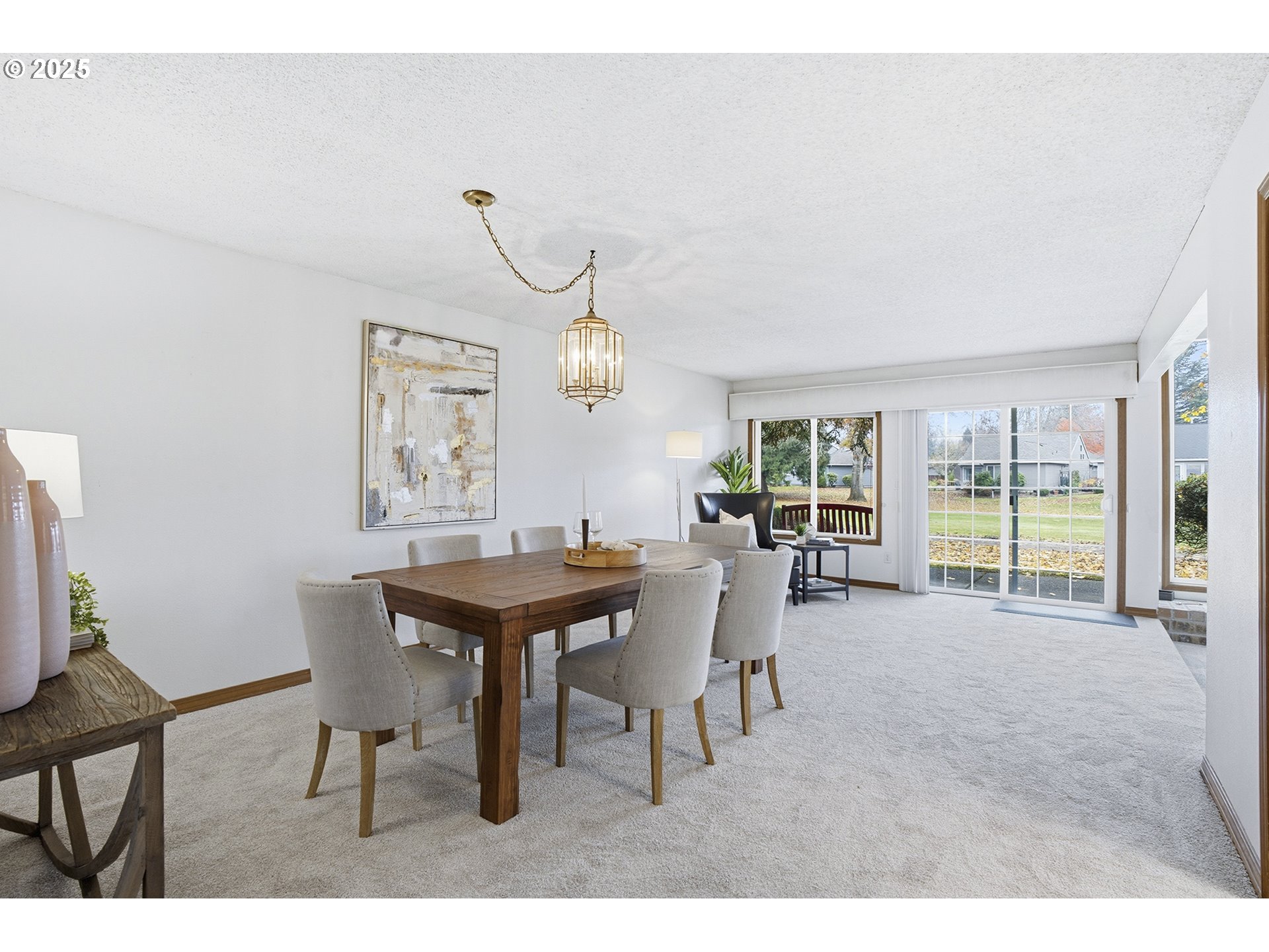 7430 Southwest Greens View Court Wilsonville, OR 97070 - Photo 7 of 48 a view of a dining room and livingroom with furniture wooden floor a rug and a chandelier