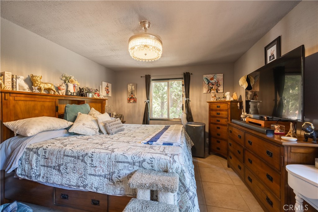 519 South Dart Canyon Road Crestline, CA 92325 - Photo 15 of 26 a bedroom with a bed and a flat screen tv