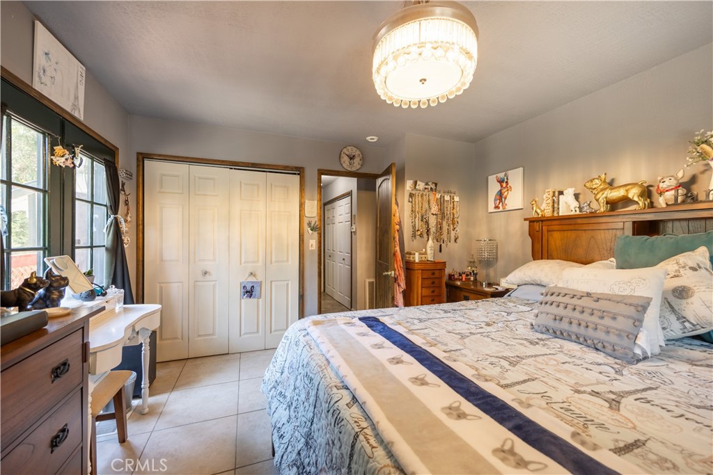 519 South Dart Canyon Road Crestline, CA 92325 - Photo 16 of 26 a bedroom with a bed and a chandelier