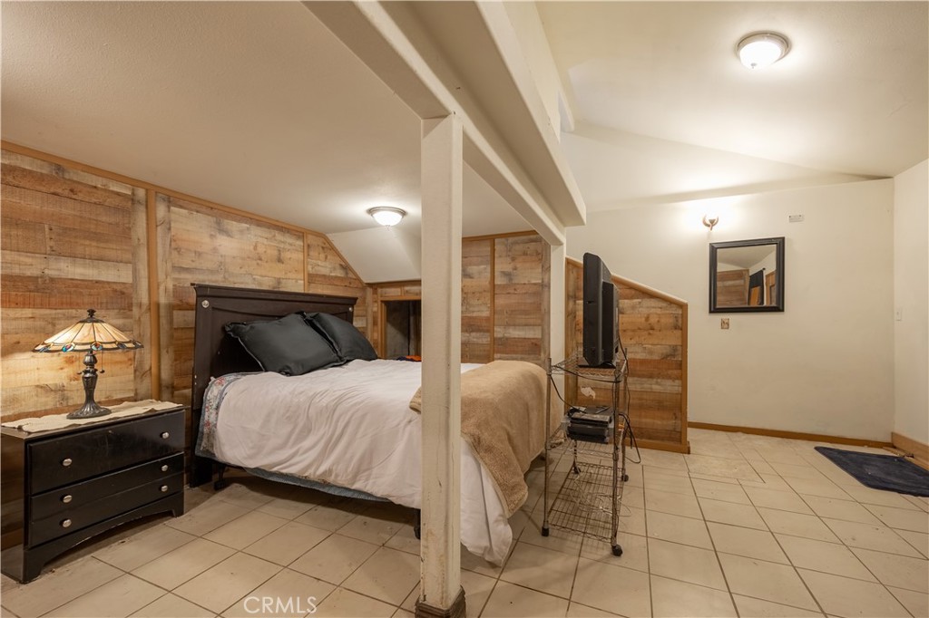 519 South Dart Canyon Road Crestline, CA 92325 - Photo 24 of 26 a bedroom with a bed and wooden floor