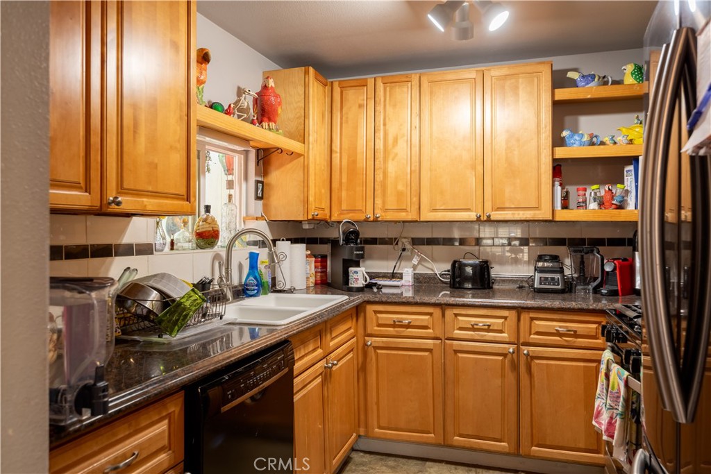 519 South Dart Canyon Road Crestline, CA 92325 - Photo 7 of 26 a kitchen with stainless steel appliances granite countertop a sink a stove and cabinets
