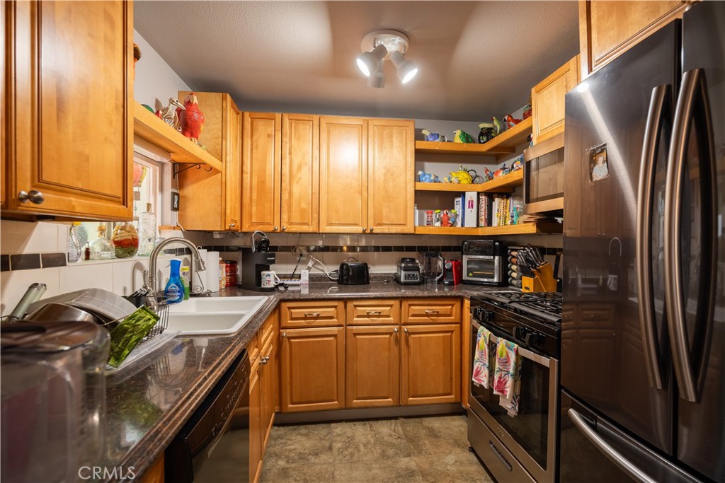 519 South Dart Canyon Road Crestline, CA 92325 - Photo 8 of 26 a kitchen with stainless steel appliances granite countertop a stove a sink and a refrigerator