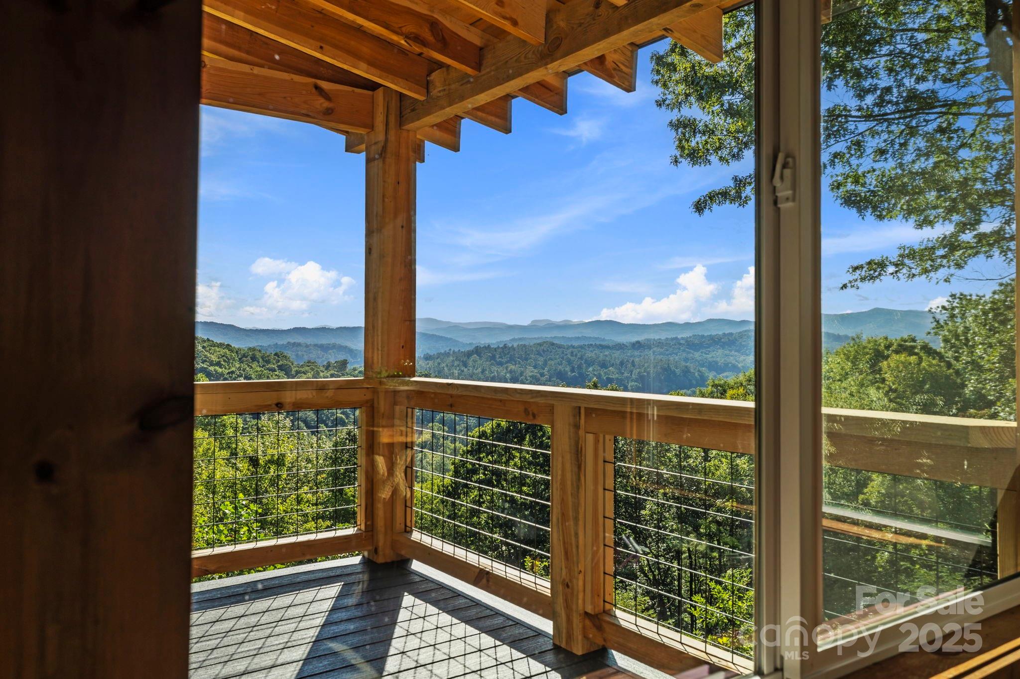 658 Johnson Road Brevard, NC 28712 - Photo 24 of 48 a view of a balcony with a floor to ceiling window wooden floor and wooden fence