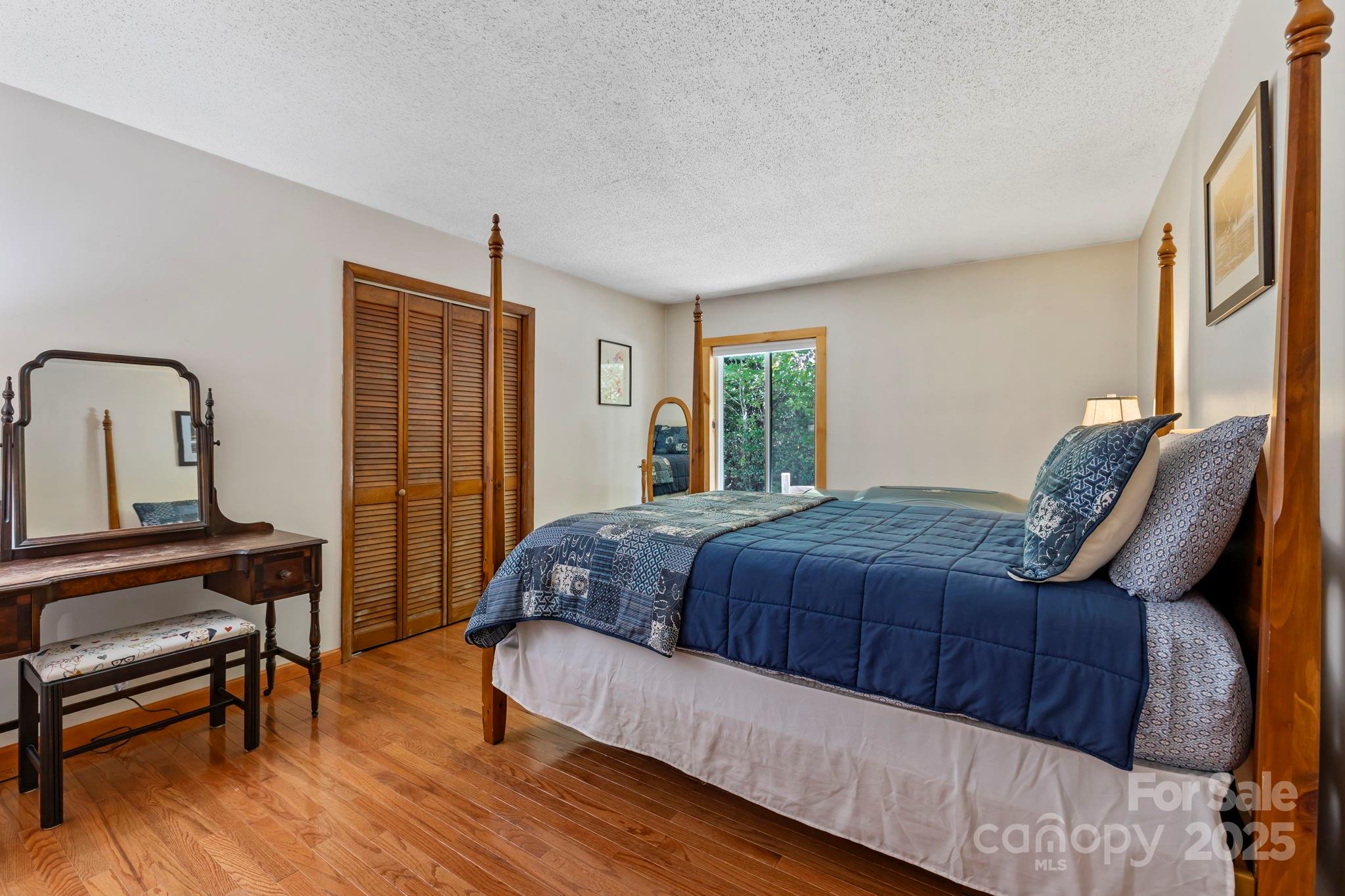 658 Johnson Road Brevard, NC 28712 - Photo 25 of 48 a bedroom with a bed wooden floor and window
