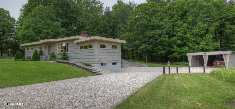 195 Main Road Monterey, MA 01245 - Photo 2 of 30 a front view of a house with a garden
