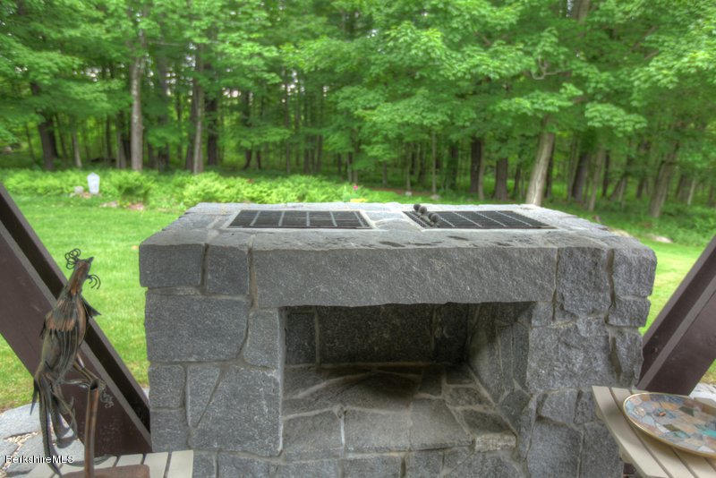 195 Main Road Monterey, MA 01245 - Photo 18 of 30 a backyard of a house with lots of green space and fountain