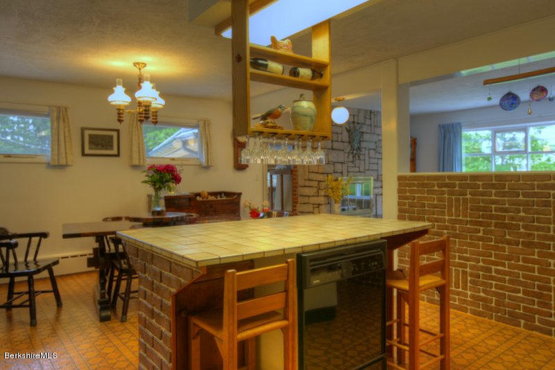 195 Main Road Monterey, MA 01245 - Photo 30 of 30 a dining room with a wooden table and chairs