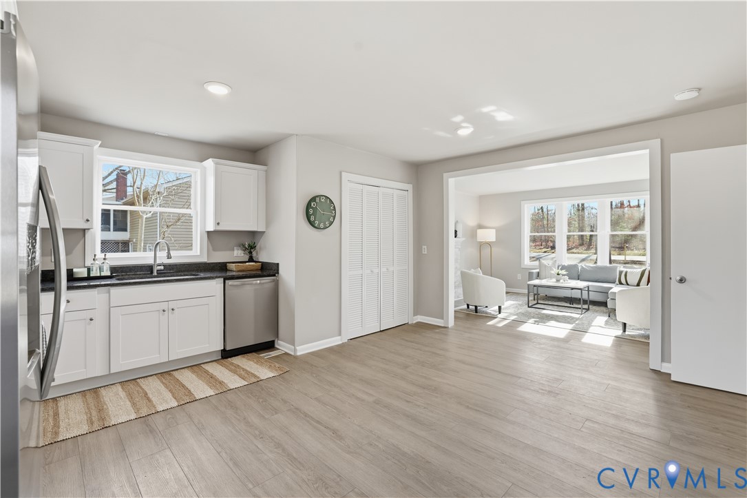 4400 Treely Road Chester, VA 23831 - Photo 13 of 34 a large white kitchen with granite countertop a stove a sink and a refrigerator