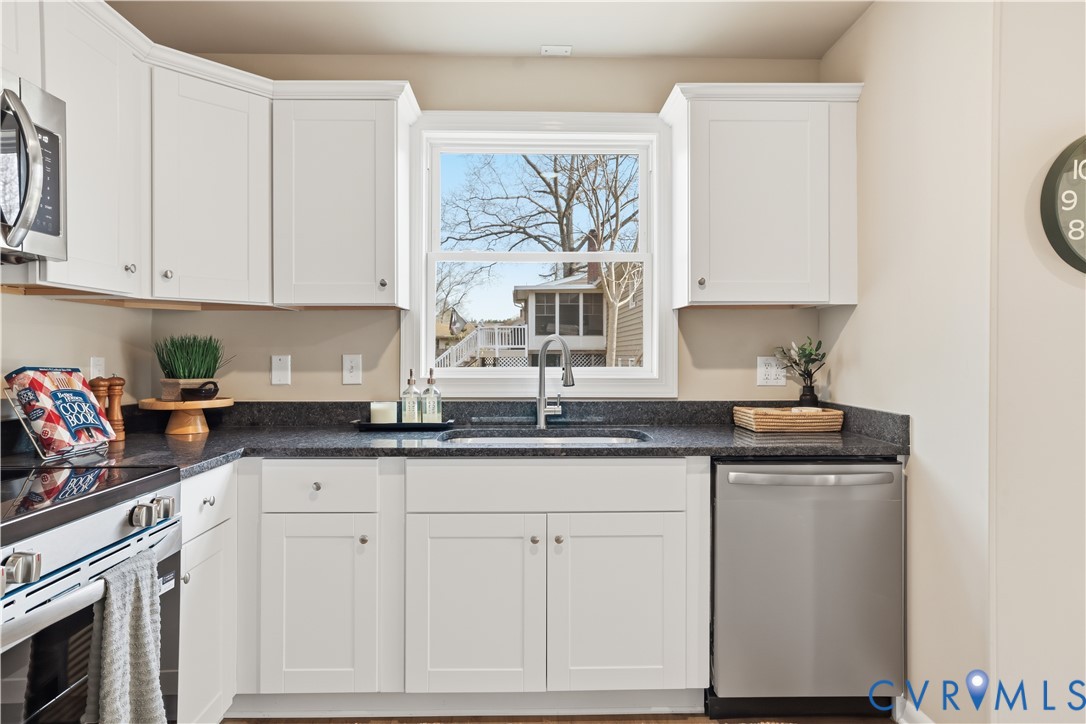 4400 Treely Road Chester, VA 23831 - Photo 17 of 34 a kitchen with granite countertop white cabinets and white appliances