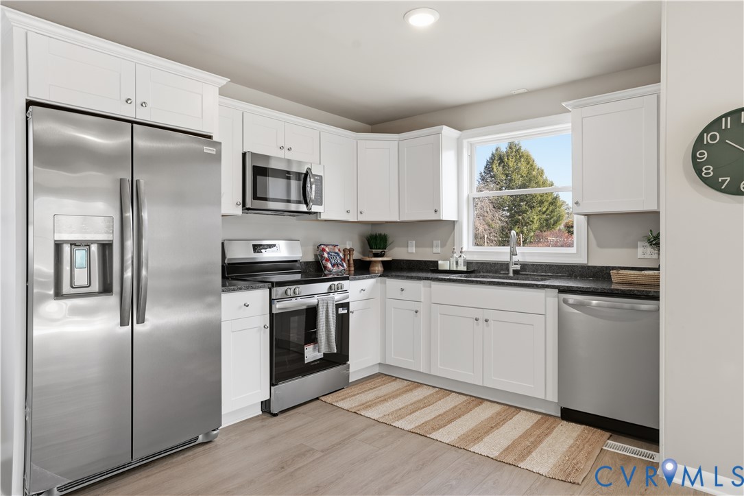 4400 Treely Road Chester, VA 23831 - Photo 18 of 34 a kitchen with stainless steel appliances granite countertop a refrigerator sink and stove