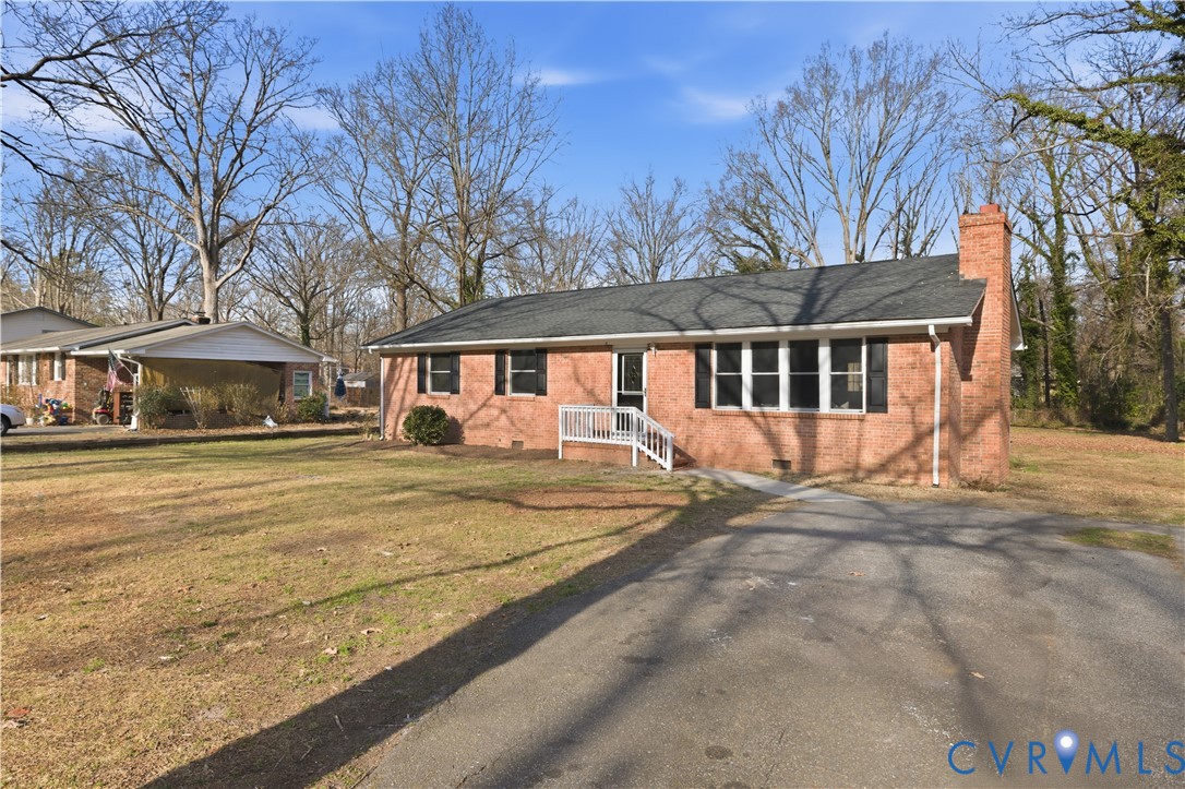 4400 Treely Road Chester, VA 23831 - Photo 2 of 34 a front view of a house with a yard and trees