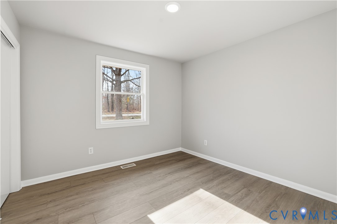 4400 Treely Road Chester, VA 23831 - Photo 25 of 34 an empty room with wooden floor and windows