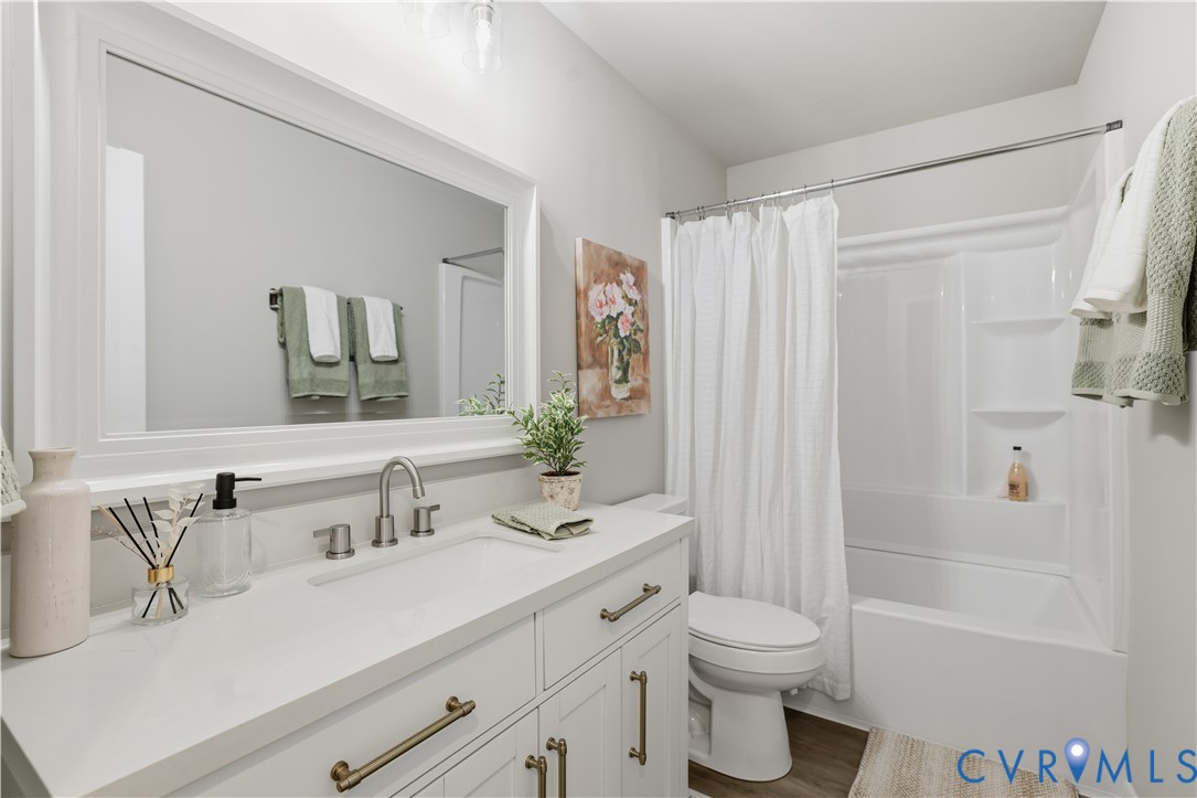 4400 Treely Road Chester, VA 23831 - Photo 27 of 34 a bathroom with a double vanity sink toilet and shower