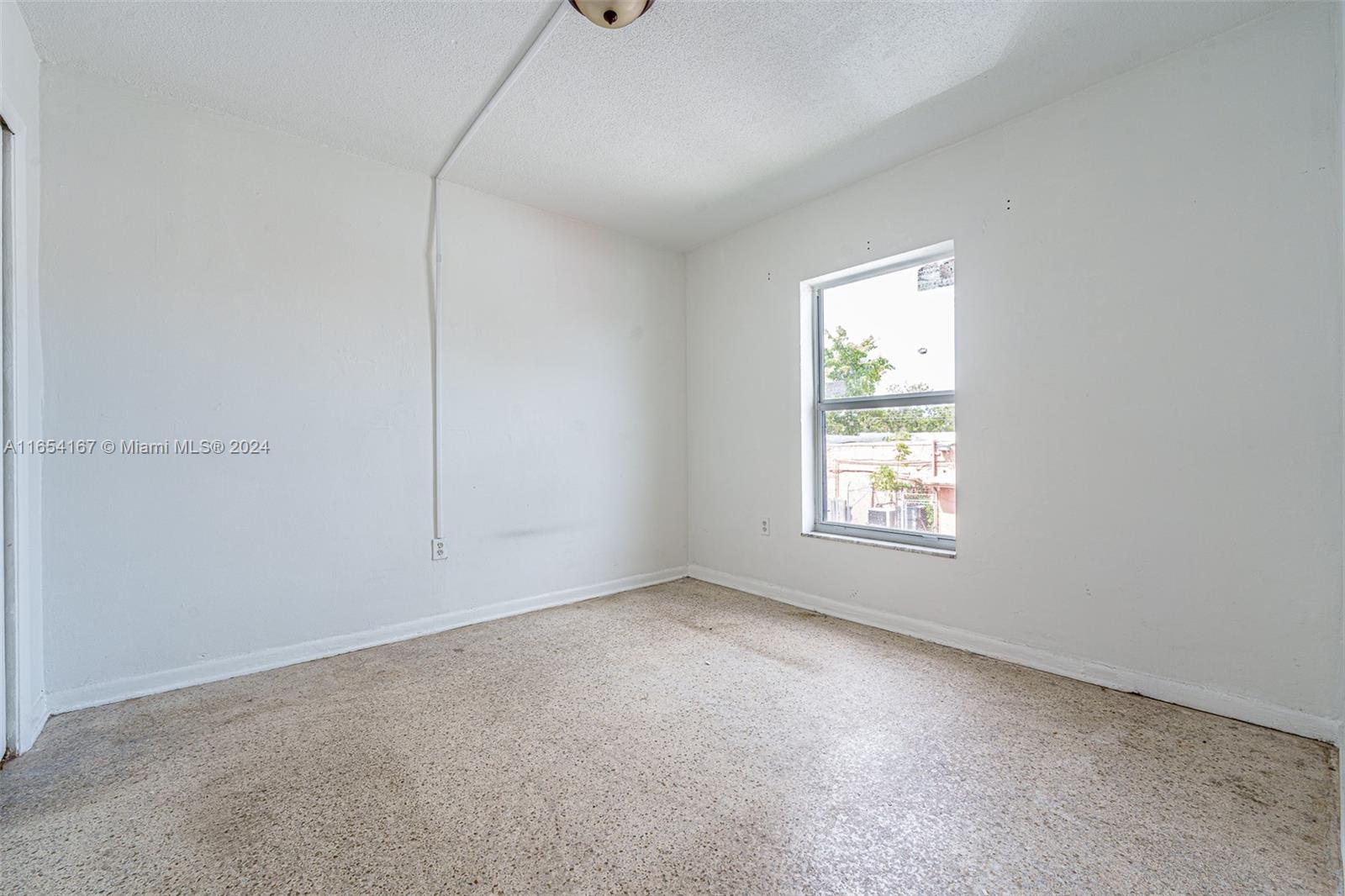 621 Southwest 15th Avenue, Unit 4 Miami, FL 33135 - Photo 13 of 22 an empty room with a window